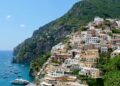 Positano romantic sunset view with colorful houses and boats.