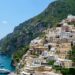 Positano romantic sunset view with colorful houses and boats.
